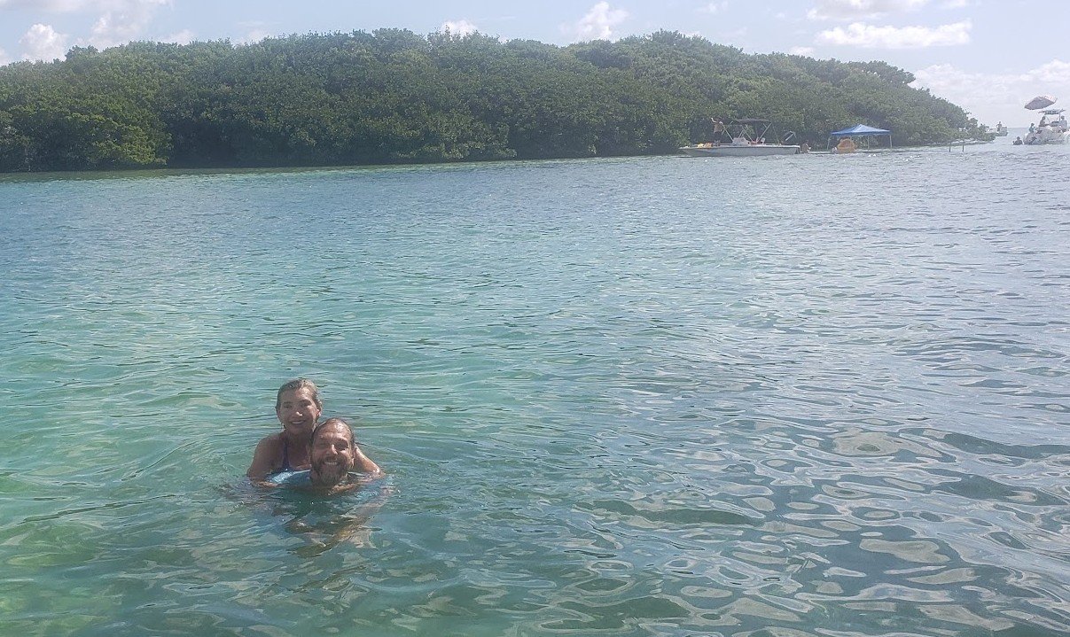 Couple swimming on a Key Biscayne sandbar Miami boat tour